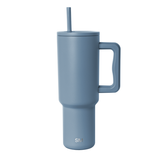 Slate blue insulated tumbler with tapered cylindrical design and minimalist contemporary aesthetic