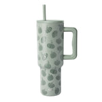 Pale sage green insulated tumbler with handle featuring an all-over pumpkin pattern in darker green, shown on white background.
