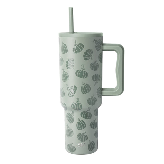 Pale sage green insulated tumbler with handle featuring an all-over pumpkin pattern in darker green, shown on white background.