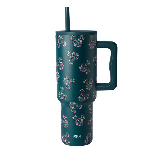 Deep teal drinkware with vibrant floral pattern in hot pink, coral, magenta, white, cream, and yellow accents.
