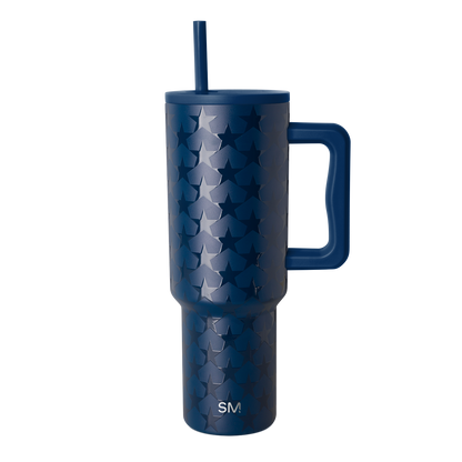 Deep navy blue tumbler with silvery-blue tonal pattern, isolated on white background