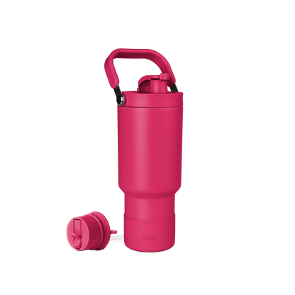 Bright pink school backpack with black carrying handle on white background