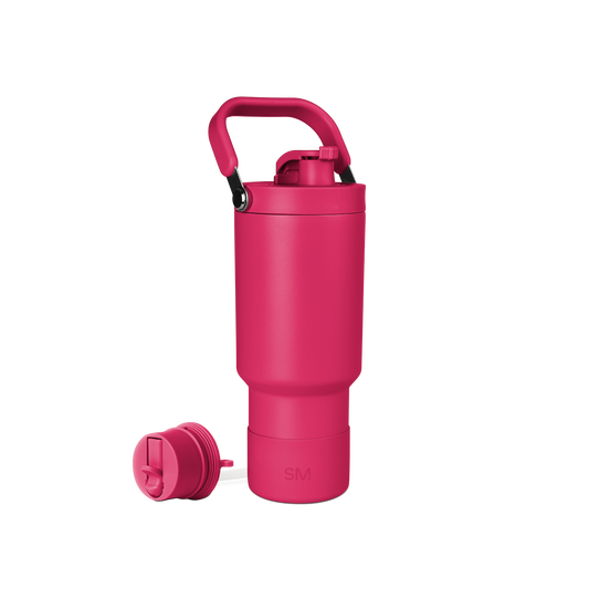 Bright pink school backpack with black carrying handle on white background