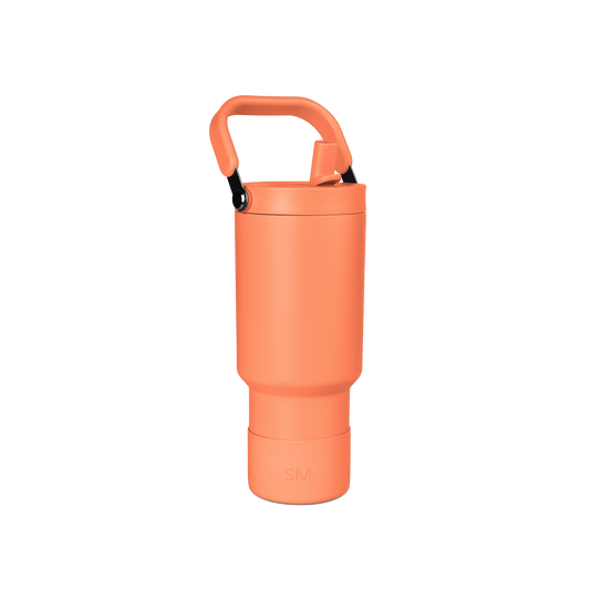Coral-orange tumbler with black accents, viewed from the side showing the full cylindrical shape and smooth surface finish.