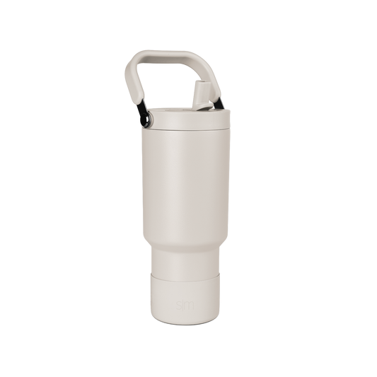 Pale beige cylindrical vessel with cream-colored closure cap on neutral off-white background.