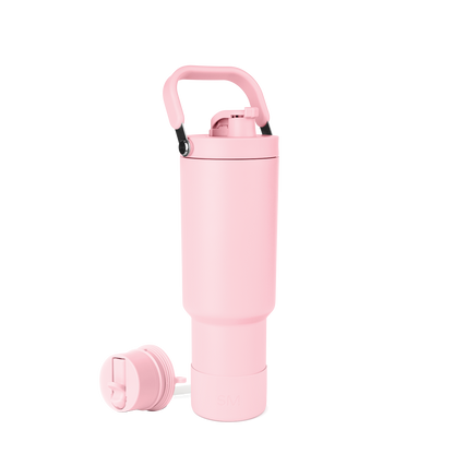 Pale pink trapezoid-shaped bottle with black carry handle grips and interior hardware components