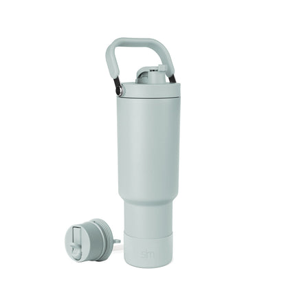 Soft sage green water bottle with black accents and carrying handle