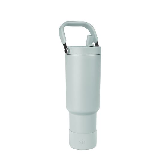 Sage green tumbler with black accents, featuring a modern minimalist design with soft muted tones and contemporary styling.