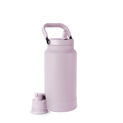 Dusty lavender pink schnapps bottle with black carabiners on handle against white background