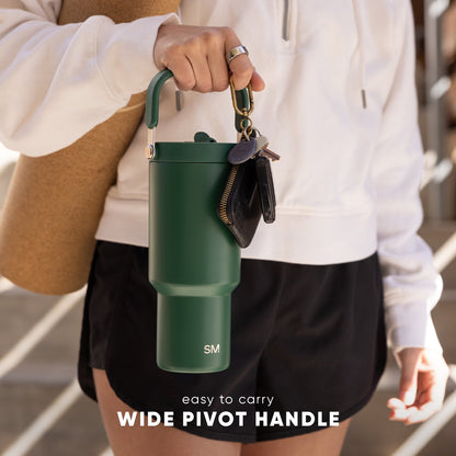 Forest green Trek-Pivot-30 water bottle with pivot handle, displayed in person's hand wearing cream-colored clothing