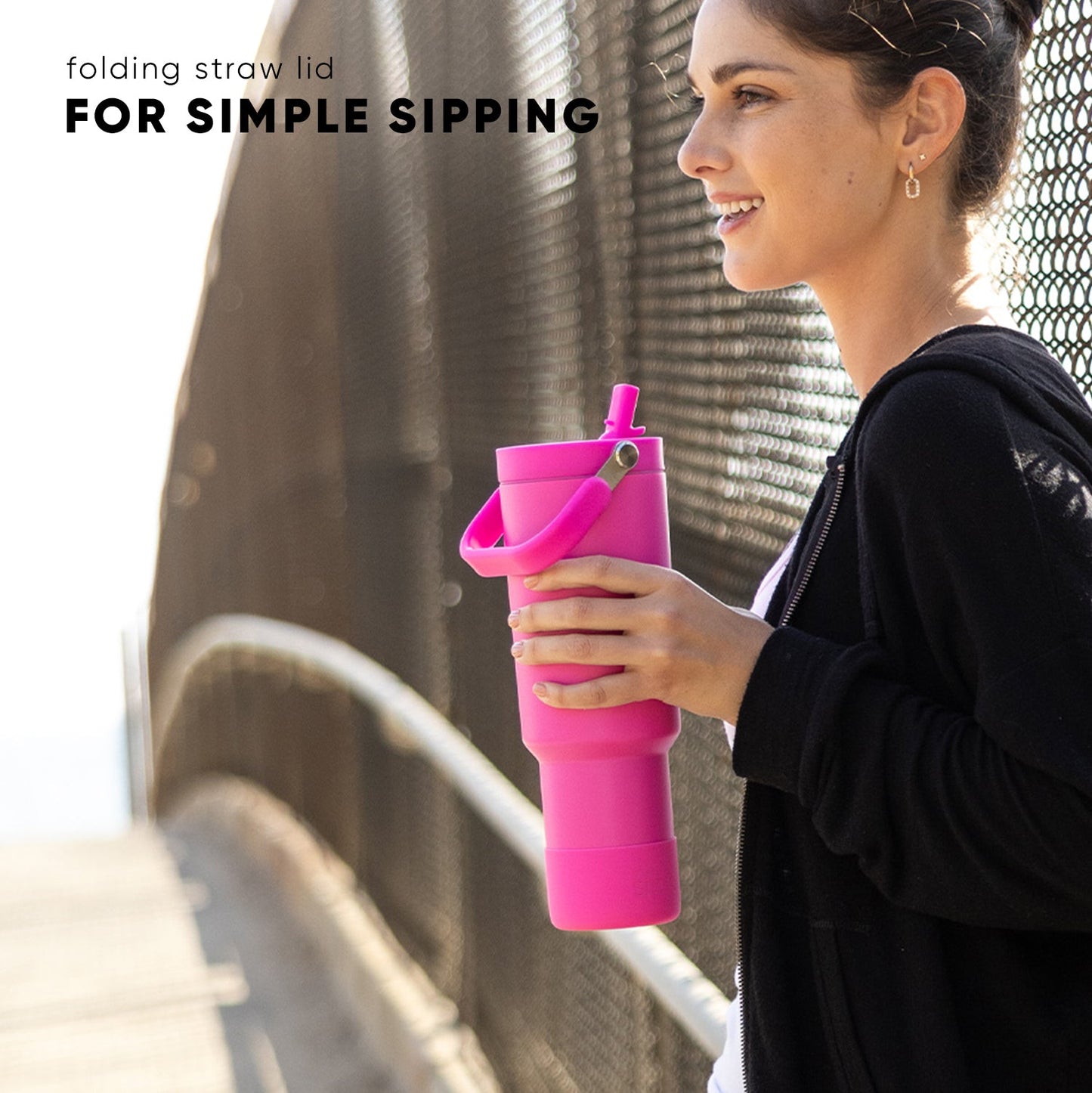 Hot pink folding reusable straw displayed upright against a neutral beige and gray background, part of the Trek-Pivot-40 sustainable drinkware collection.