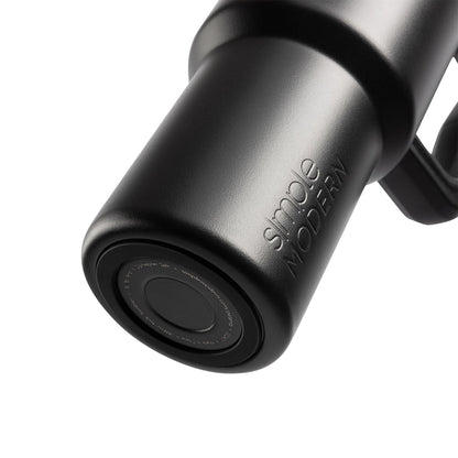 Matte black silicone-bottom product with metallic silver highlights reflecting light across curved surface against neutral background