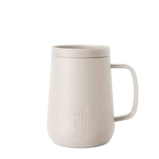 Cream-colored ceramic mug with handle on white background