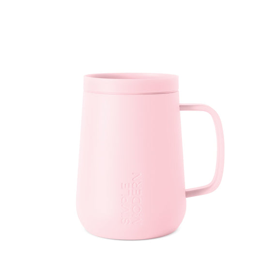 Pale pink ceramic mug on white background, viewed from front angle, featuring clean minimalist design suitable for everyday use or gifting.