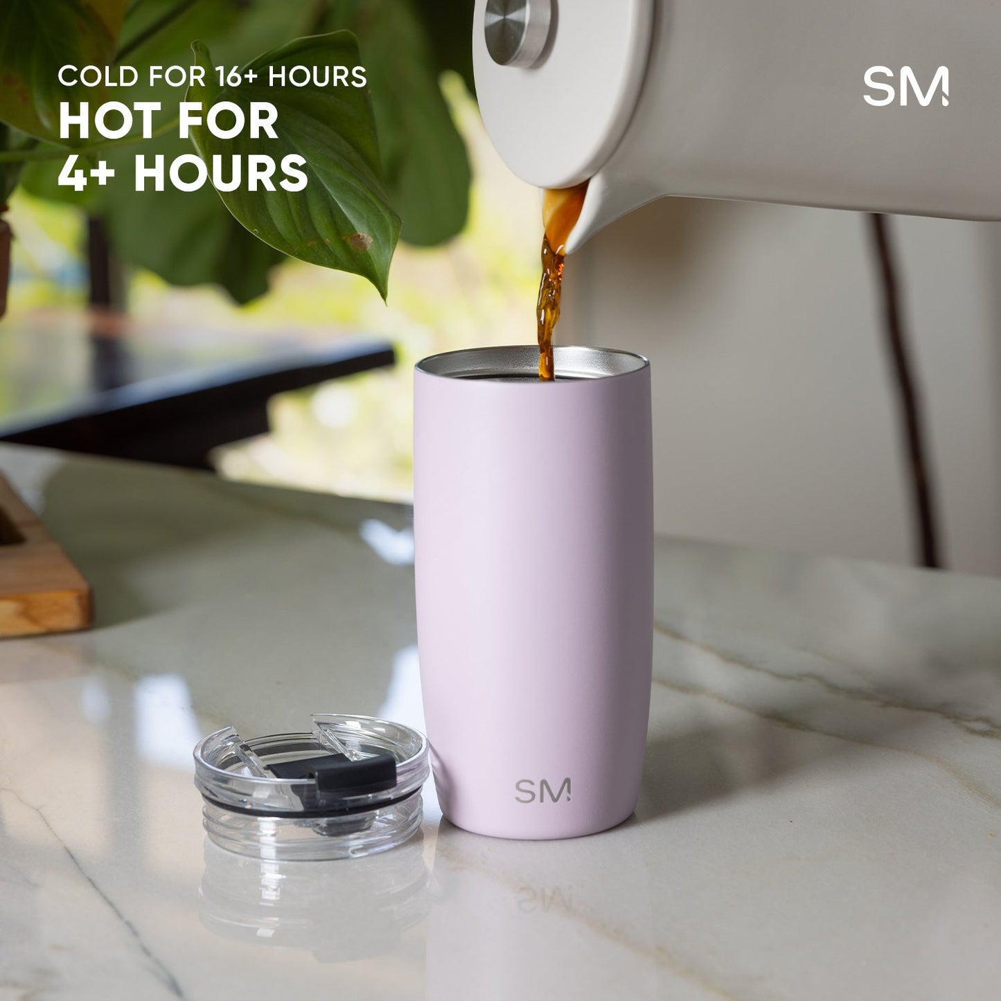 Lavender tumbler with warm amber liquid being poured into it, showcasing the Voyager hot and cold insulation features
