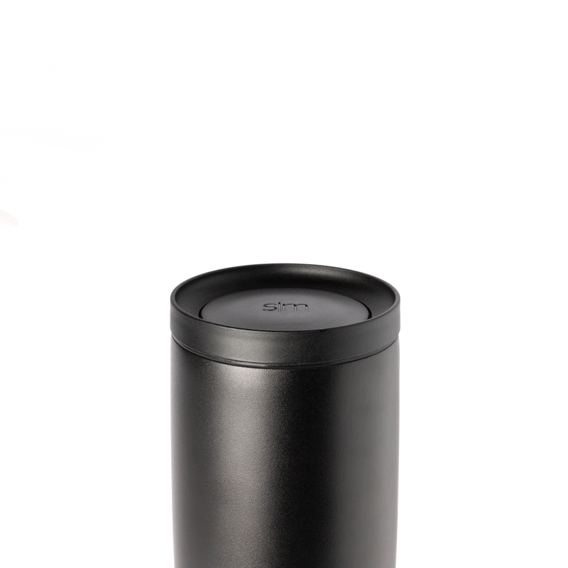 Voyager Signature 360 push button lid in matte black with gray undertones, featuring a dark charcoal finish against a light gray background.