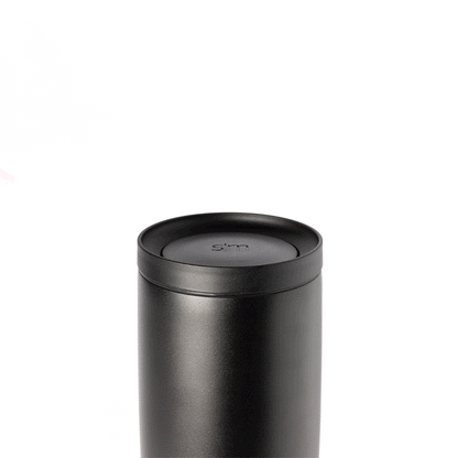 Voyager Signature 360 push button lid in matte black with gray undertones, featuring a dark charcoal finish against a light gray background.