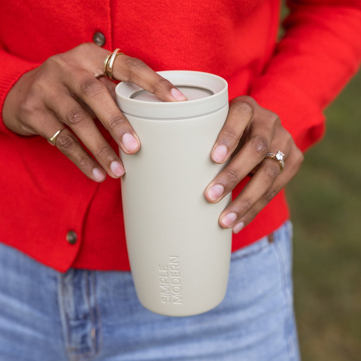 Red silicone-base product displayed against cream background, showcasing texture and durability of the material construction.